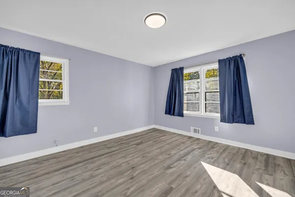 a view of a backyard with large trees