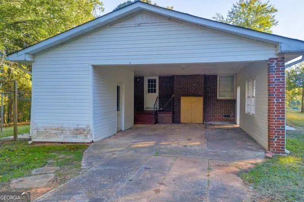 a view of backyard with barbeque grill and a big yard