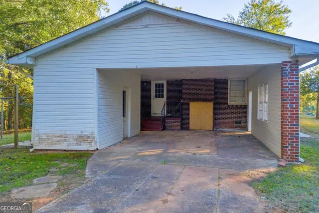 a view of backyard with barbeque grill and a big yard