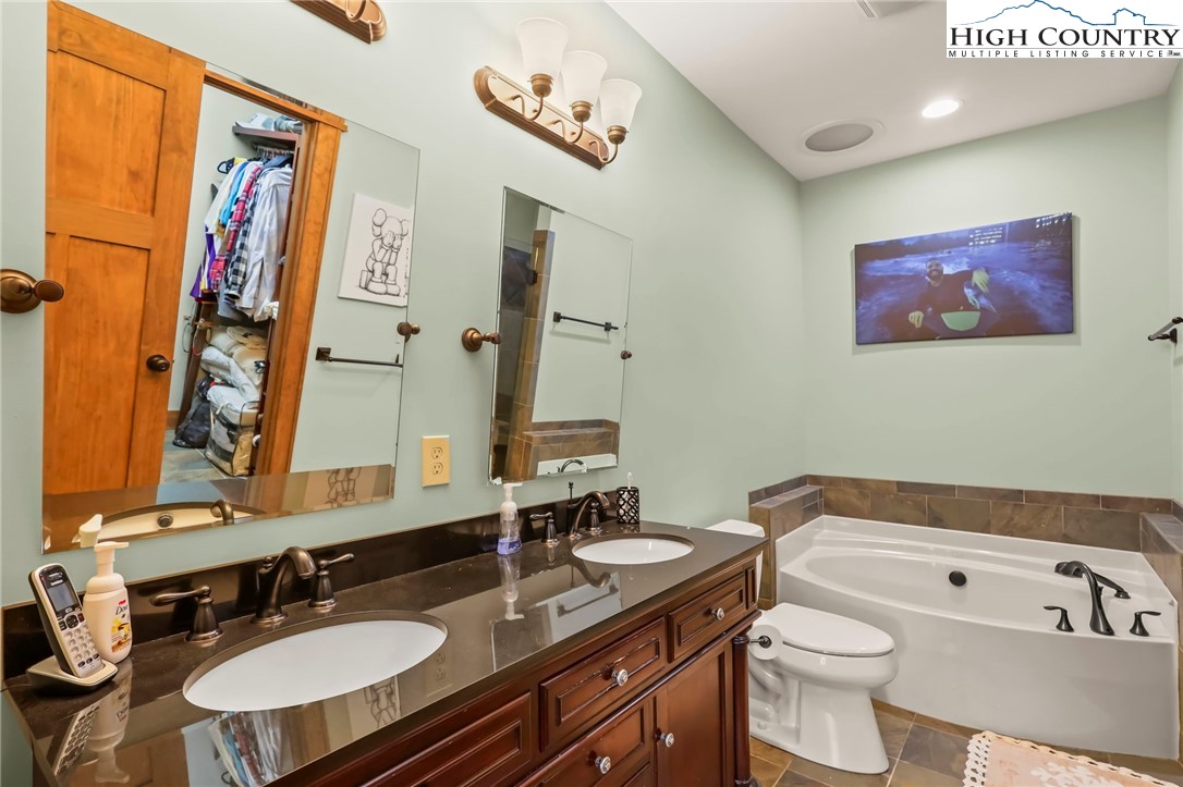 138 South Camp Road, Unit 103 Boone, NC 28607 - Photo 24 of 50 a bathroom with a tub sink and mirror