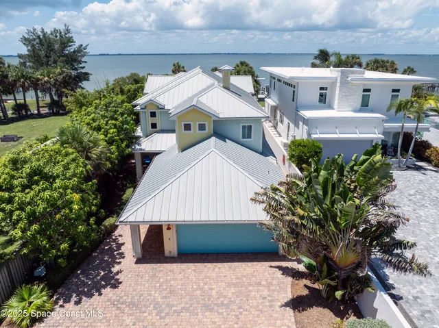 an aerial view of a house with a yard and potted plants