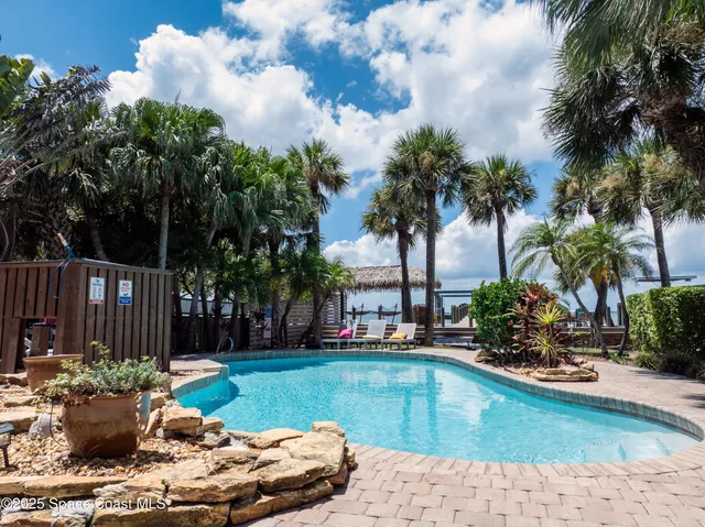 a living room with furniture and a mirror
