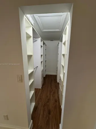 a view of walk in closet with empty racks