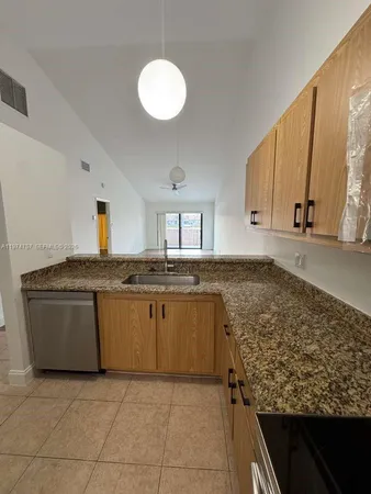 a kitchen with a sink cabinets and stainless steel appliances