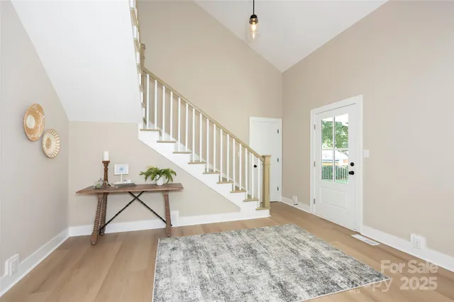 a view of entryway and hall with wooden floor