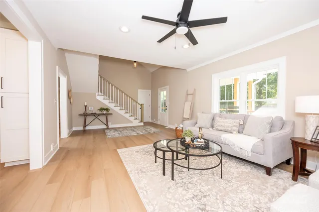 a living room with furniture and a wooden floor