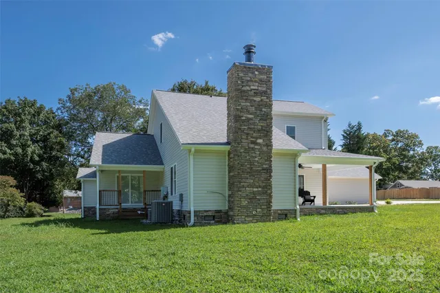 a front view of a house with a garden and yard