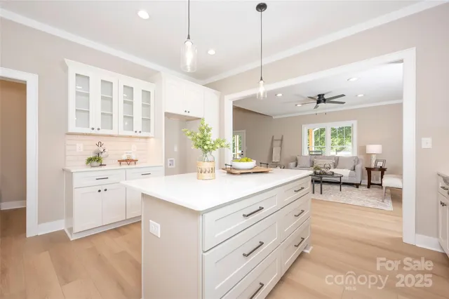 a kitchen with sink stove and cabinets
