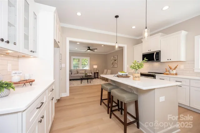 a kitchen with a sink a counter top space appliances and cabinets
