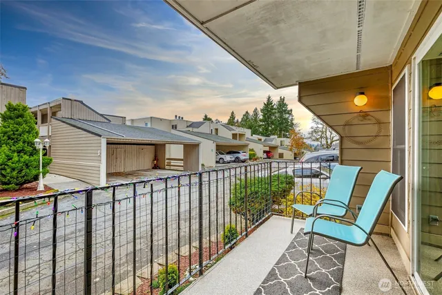 a view of a chair and tables in the balcony