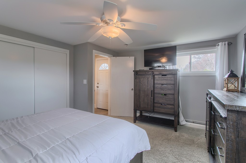 547 Boston Road Billerica, MA 01821 - Photo 14 of 23 a bedroom with a bed and a television
