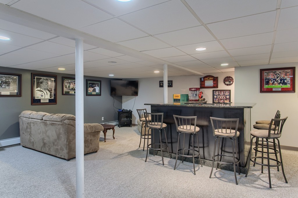 547 Boston Road Billerica, MA 01821 - Photo 19 of 23 a living room with furniture and a dining table with chairs