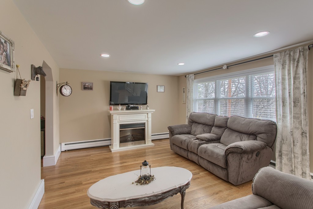547 Boston Road Billerica, MA 01821 - Photo 6 of 23 a living room with furniture flat screen tv and a fireplace