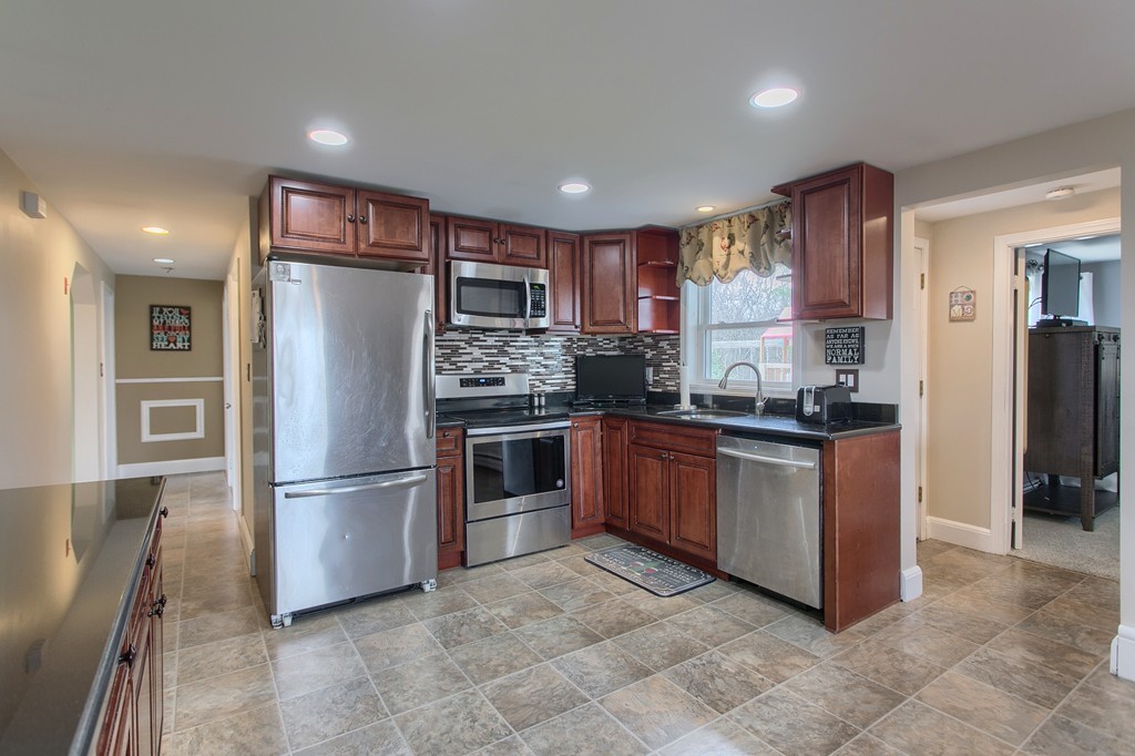 547 Boston Road Billerica, MA 01821 - Photo 10 of 23 a kitchen with stainless steel appliances granite countertop a refrigerator and a stove
