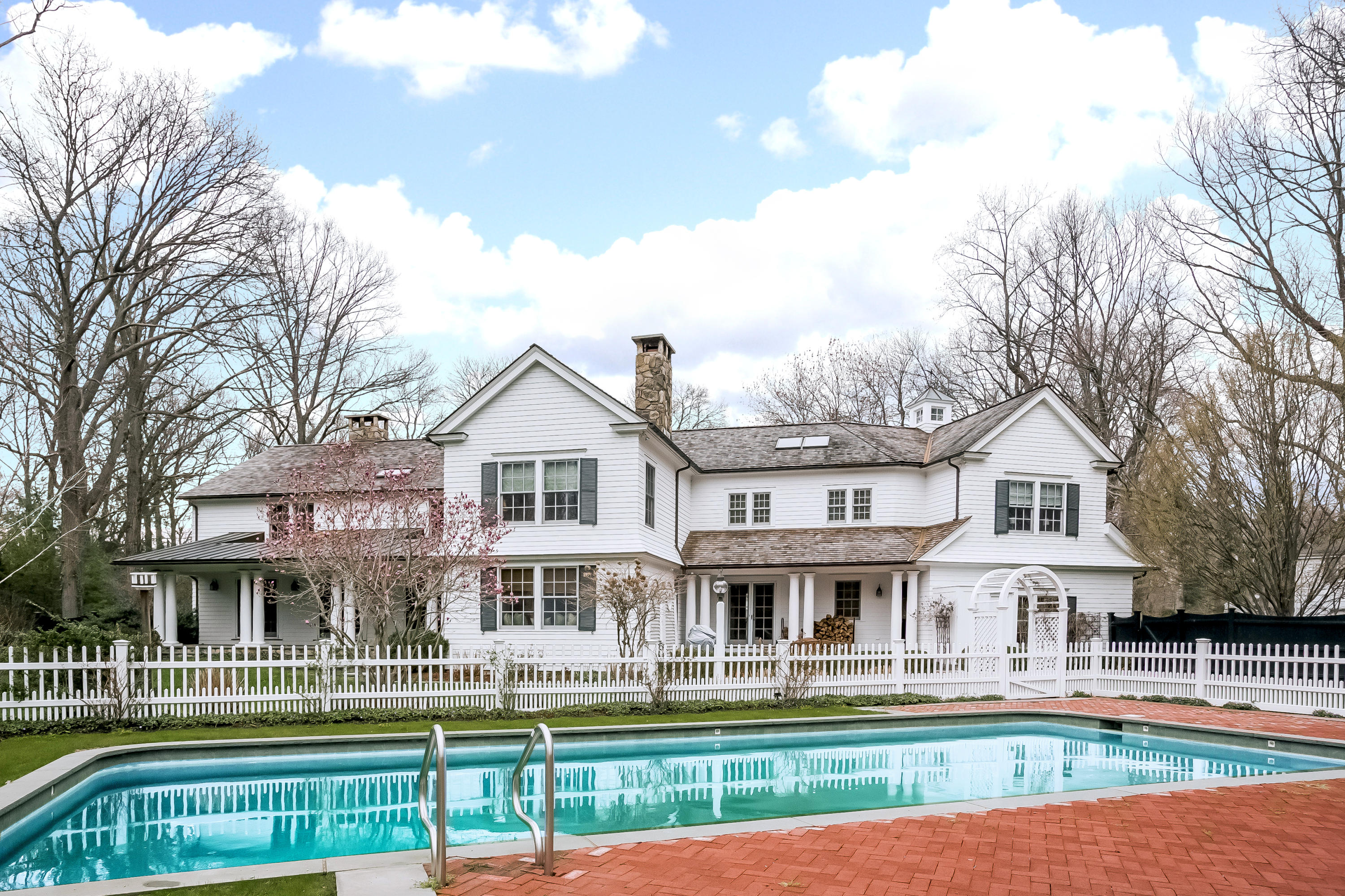 8 Haskell Lane Darien, CT 06820 - Photo 25 of 31 a front view of residential houses with yard and trees in the background