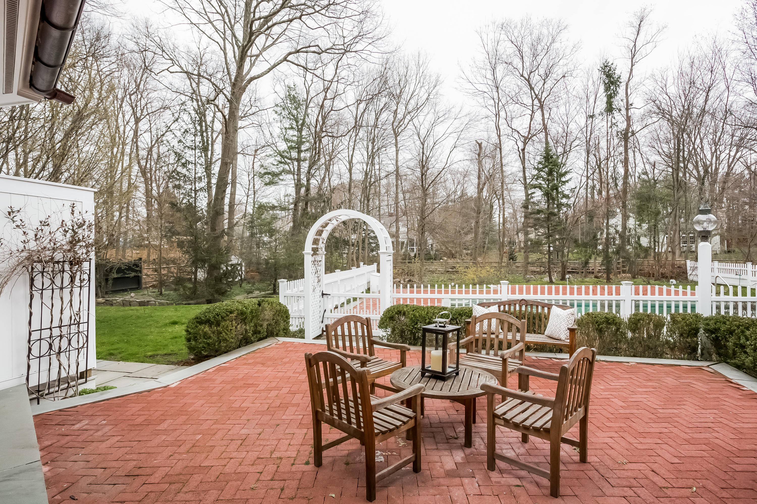 8 Haskell Lane Darien, CT 06820 - Photo 26 of 31 a backyard of a house with table and chairs