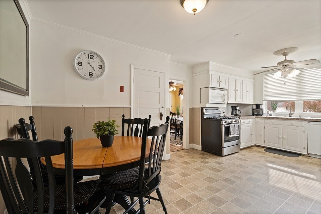 57 Chadwick Road Haverhill, MA 01835 - Photo 13 of 25 a view of a dining room and kitchen with furniture and a clock
