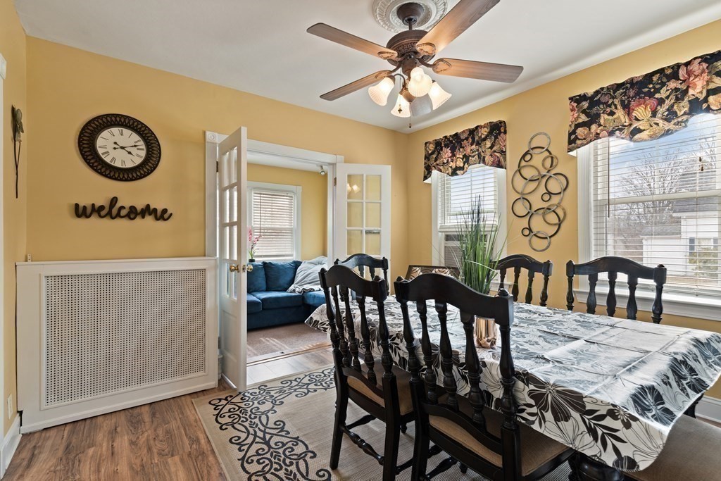 57 Chadwick Road Haverhill, MA 01835 - Photo 8 of 25 a view of a dining room and livingroom with furniture wooden floor a rug a painting and a chandelier