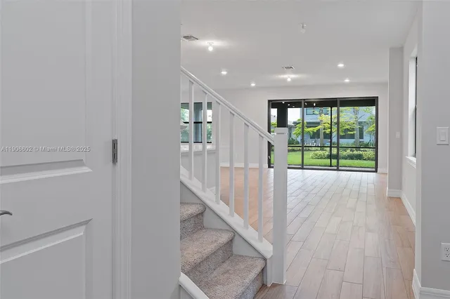 a view of entryway with wooden floor and stairs