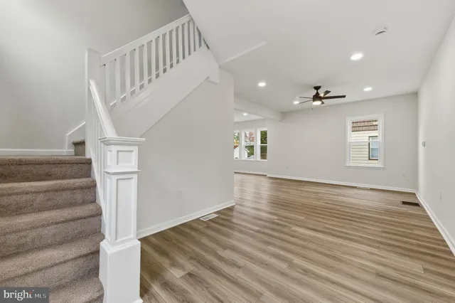 a view of entryway and hall with wooden floor