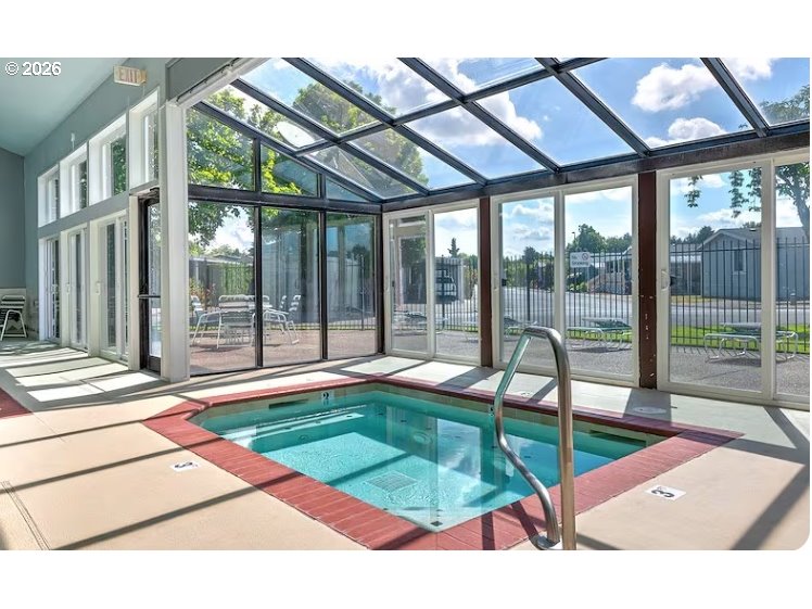 1699 North Terry Street, Unit 351 Eugene, OR 97402 - Photo 20 of 23 a swimming pool with outdoor seating and a garden