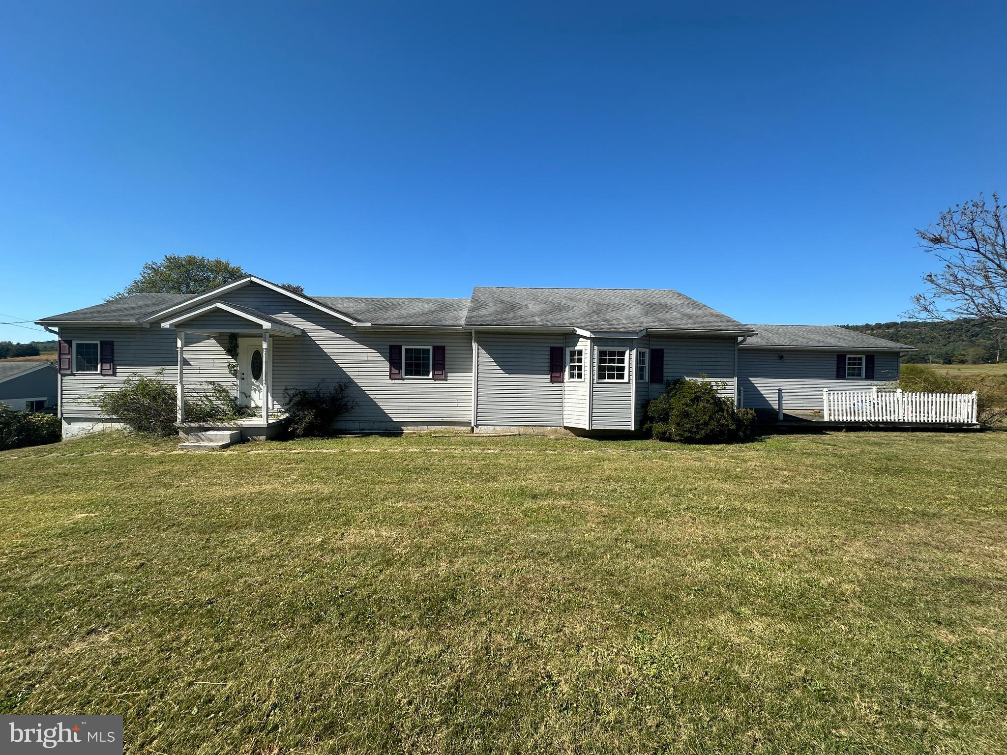 a front view of a house with a garden and porch