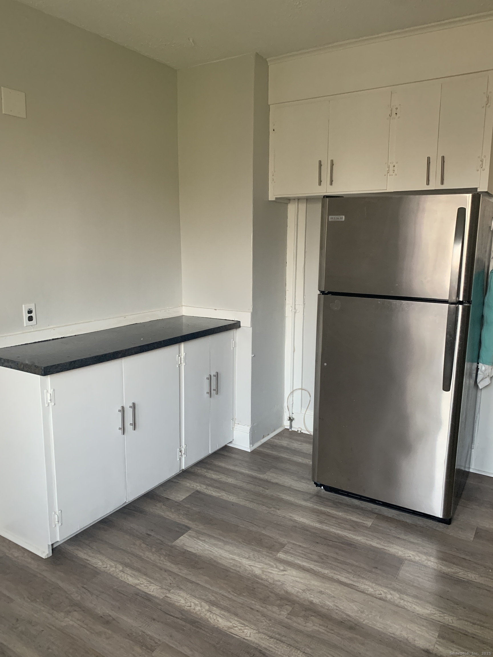 96 Seaview Terrace Bridgeport, CT 06605 - Photo 12 of 23 a view of a kitchen with refrigerator and white cabinets