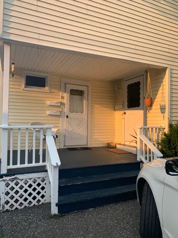 a room view with wooden floor and windows