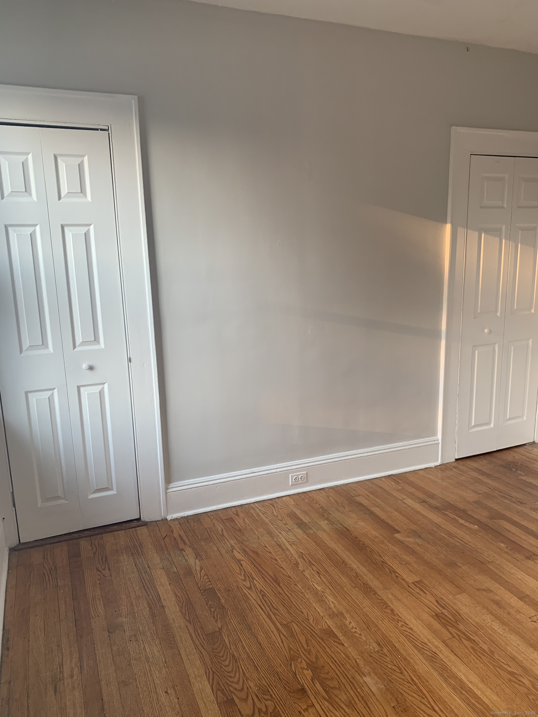 96 Seaview Terrace Bridgeport, CT 06605 - Photo 8 of 23 a view of an empty room with wooden floor