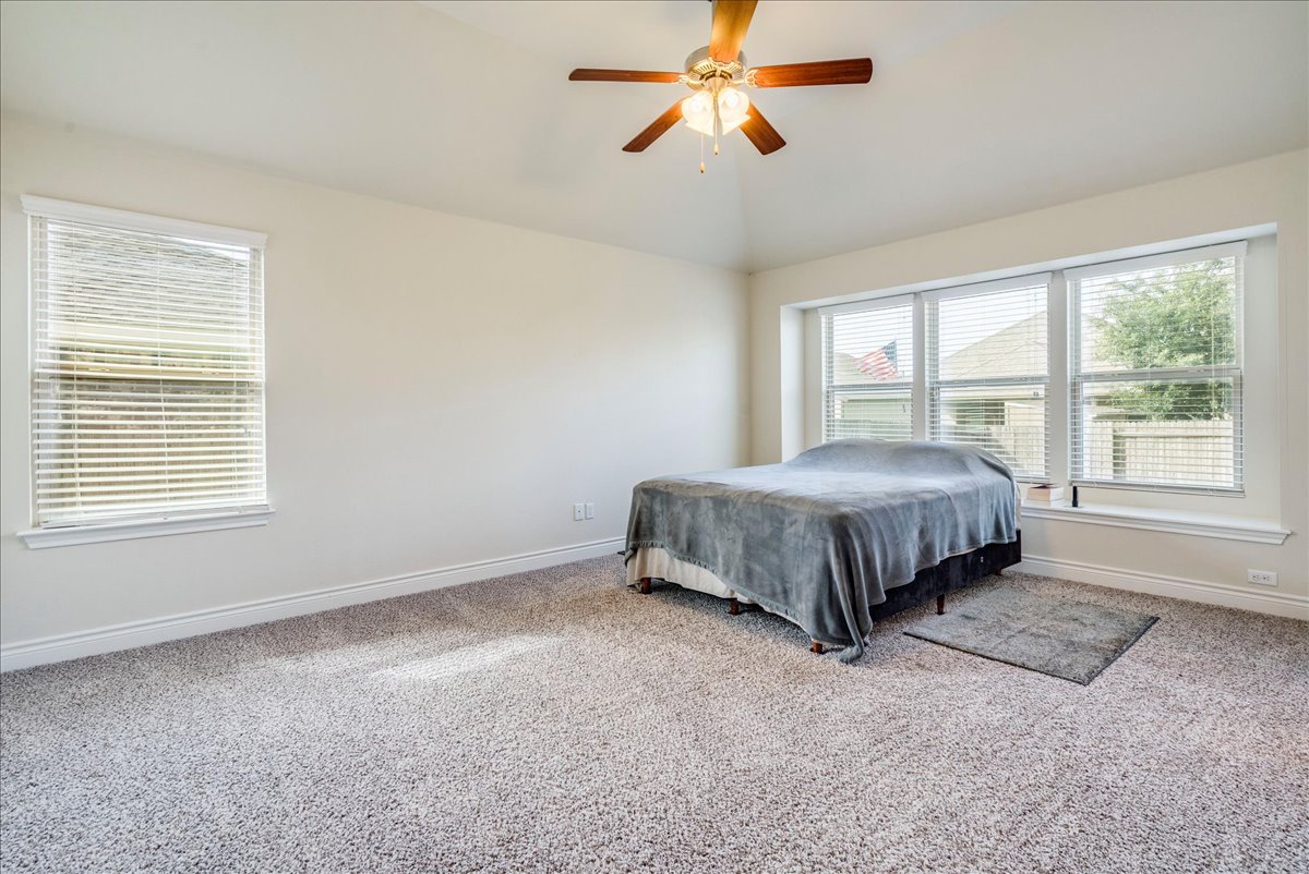 124 Compass Lane Kyle, TX 78640 - Photo 15 of 38 a bed sitting in a room next to a window