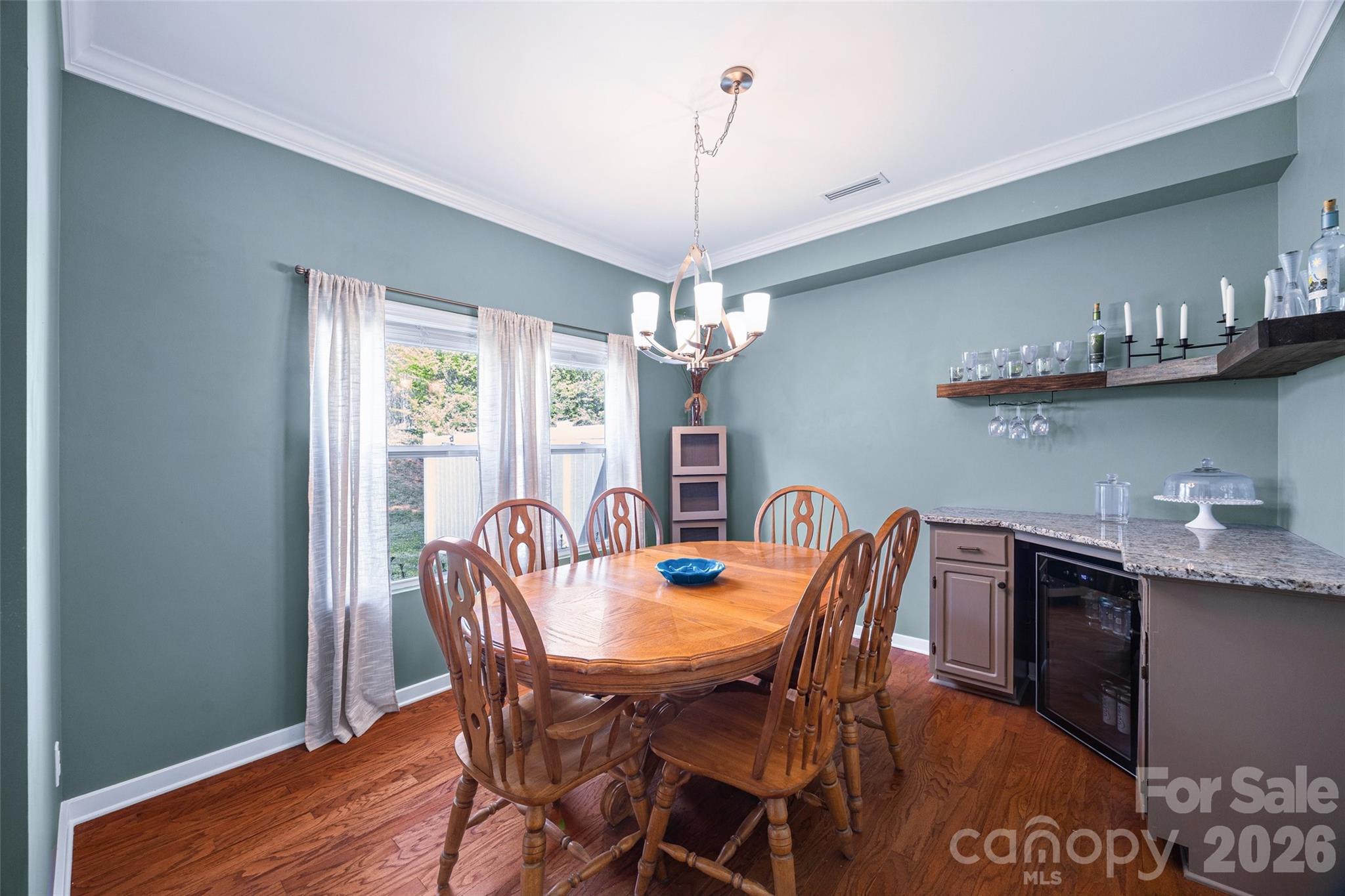 334 Battery Circle Clover, SC 29710 - Photo 12 of 29 a dining room with furniture a chandelier and wooden floor