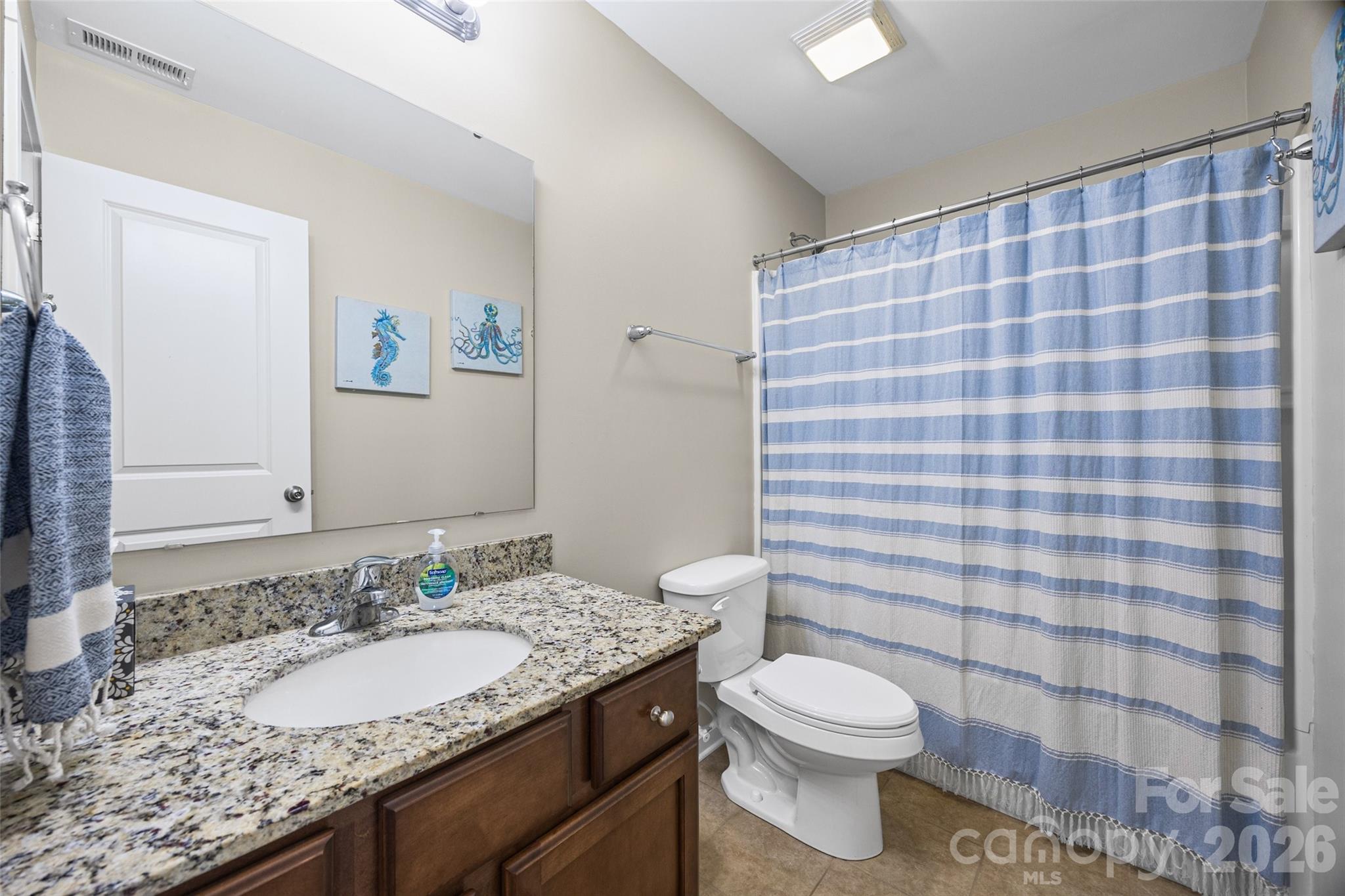334 Battery Circle Clover, SC 29710 - Photo 18 of 29 a bathroom with a granite countertop sink a toilet and a mirror