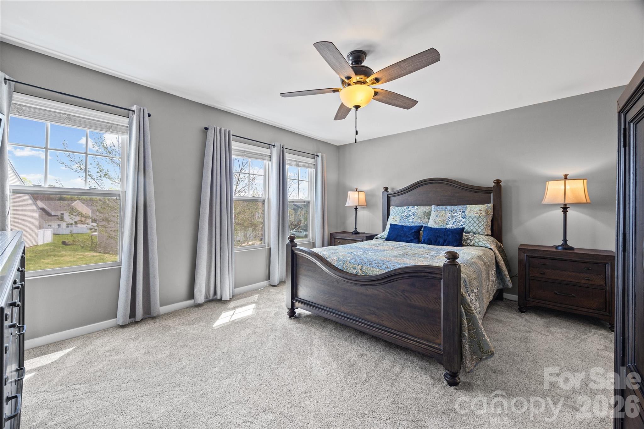 334 Battery Circle Clover, SC 29710 - Photo 20 of 29 a bedroom with a bed and a chandelier