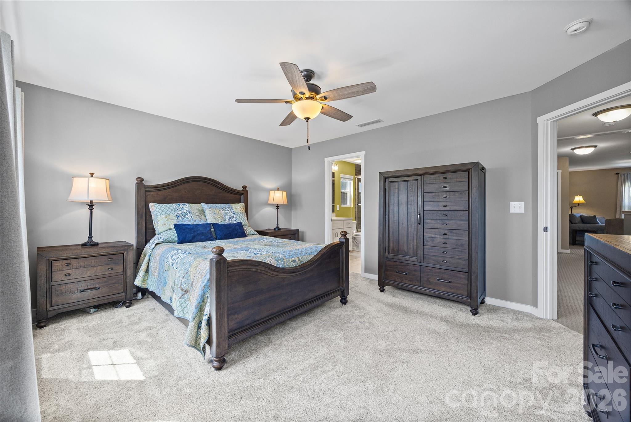 334 Battery Circle Clover, SC 29710 - Photo 21 of 29 a bedroom with a bed and a chandelier