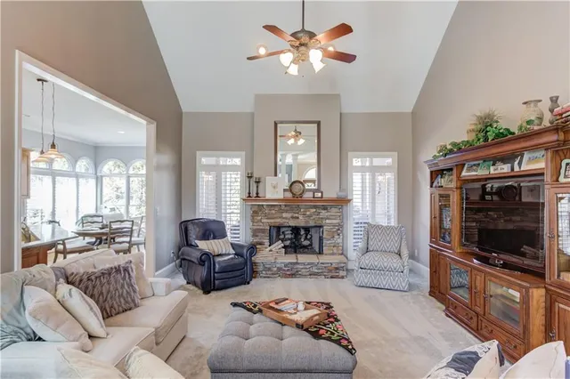 a kitchen with kitchen island granite countertop a sink a counter top space appliances and cabinets