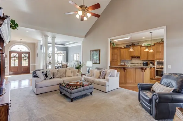 a large kitchen with stainless steel appliances sink refrigerator and cabinets