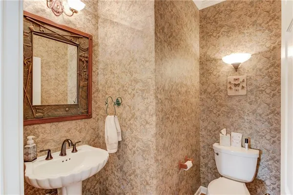 a bathroom with a granite countertop sink a mirror and shower