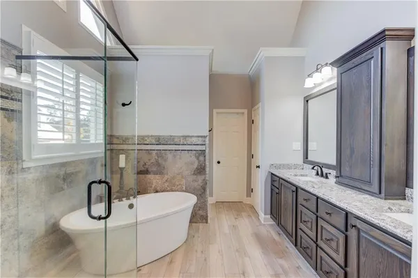 a bathroom with a sink double vanity and shower