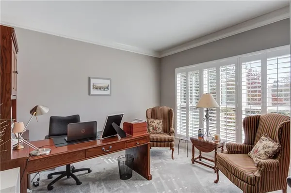 a dining room with furniture a chandelier and a rug