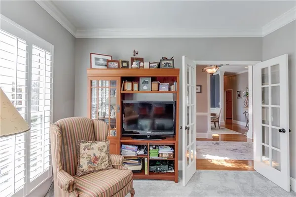 a dining room with furniture a chandelier and window