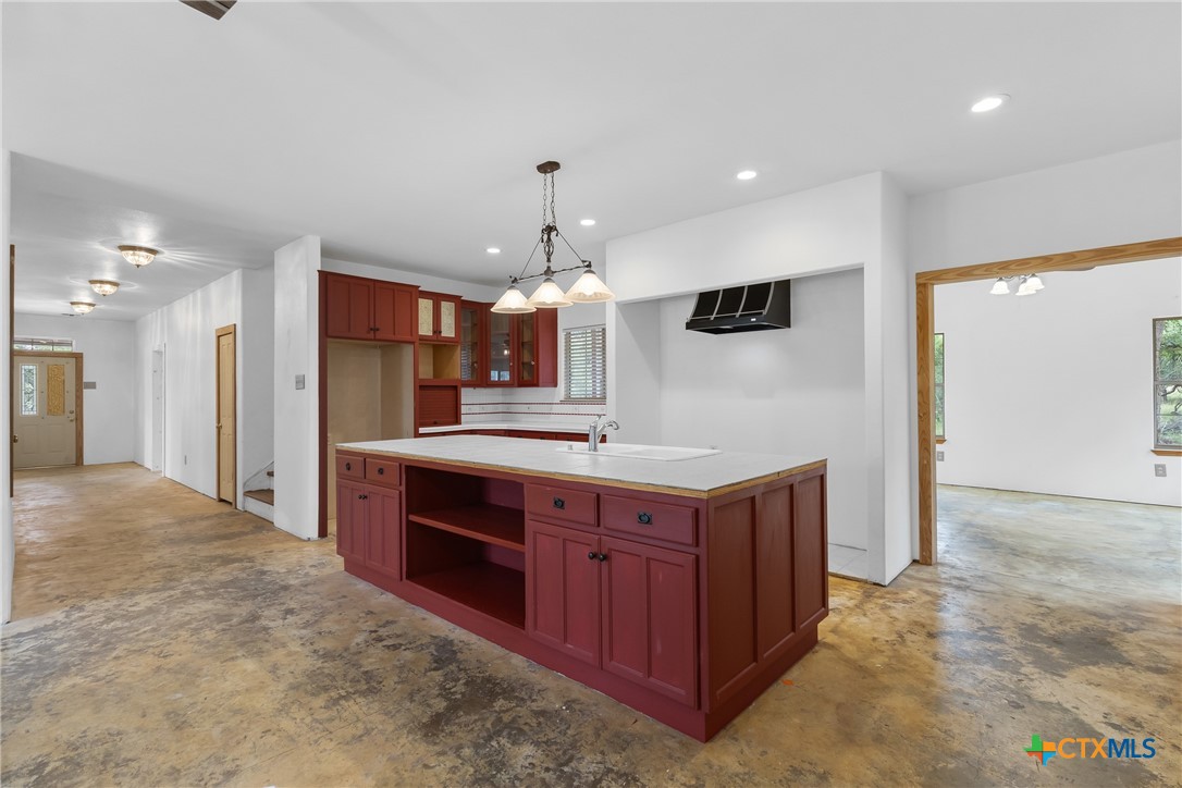 700 Camino De Rancho Wimberley, TX 78676 - Photo 13 of 41 a large kitchen with stainless steel appliances a sink and a refrigerator