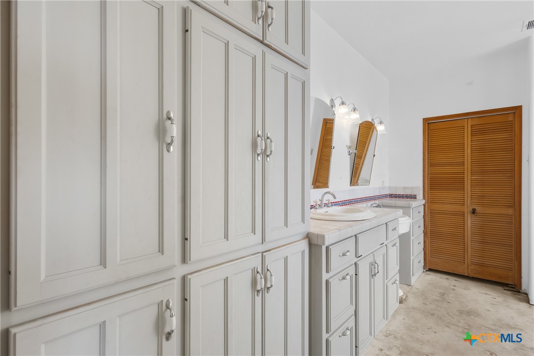 700 Camino De Rancho Wimberley, TX 78676 - Photo 21 of 41 a bathroom with a double vanity sink and mirror