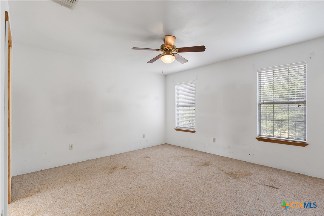700 Camino De Rancho Wimberley, TX 78676 - Photo 27 of 41 an empty room with windows and fan