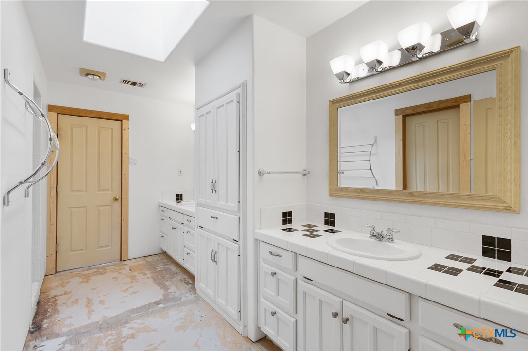 700 Camino De Rancho Wimberley, TX 78676 - Photo 29 of 41 a bathroom with a sink a vanity and a mirror
