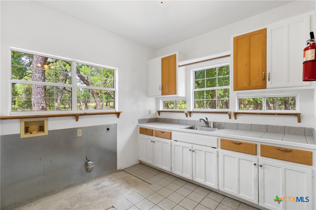 700 Camino De Rancho Wimberley, TX 78676 - Photo 31 of 41 a kitchen with a sink and large window