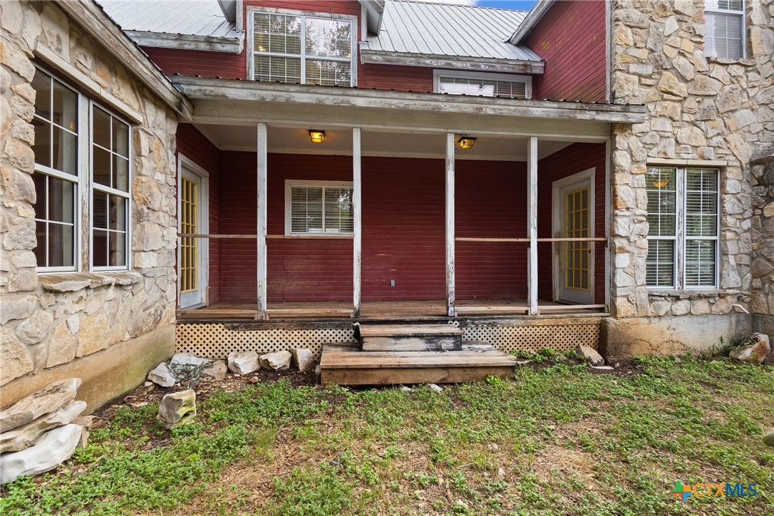 700 Camino De Rancho Wimberley, TX 78676 - Photo 34 of 41 a front view of a building with a garden and plants