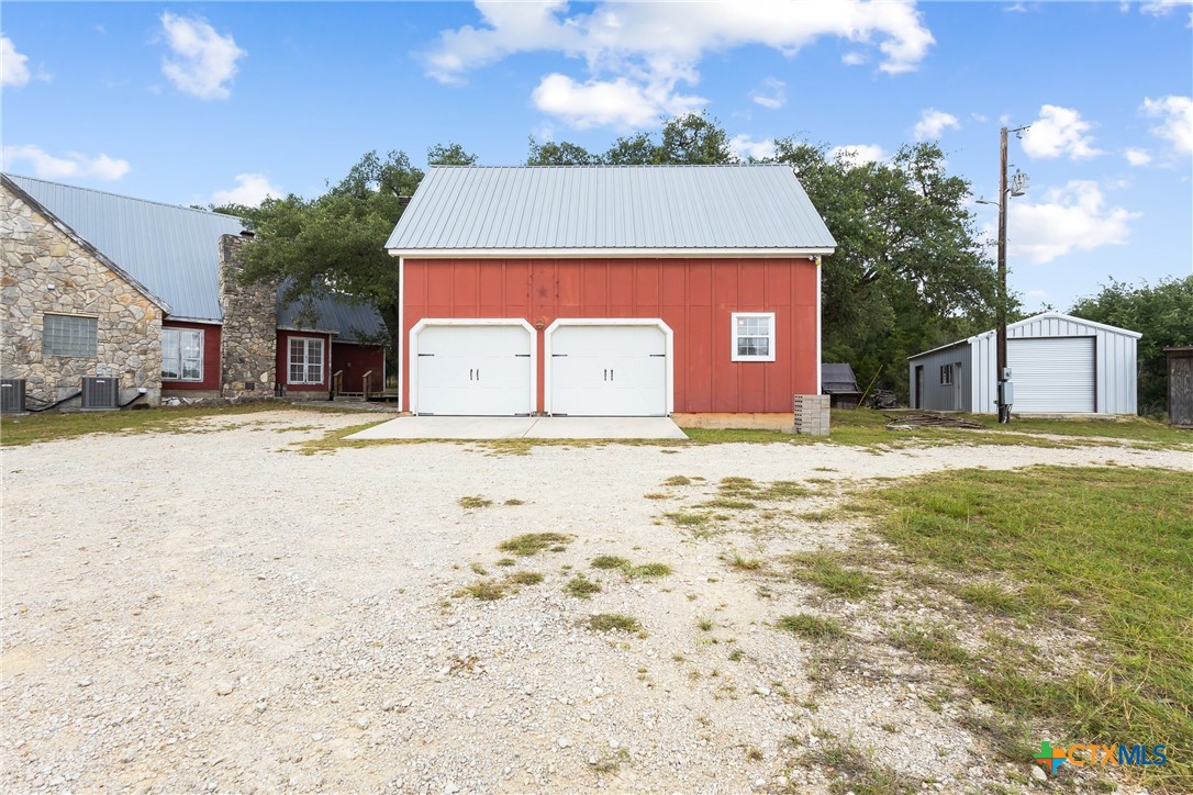 700 Camino De Rancho Wimberley, TX 78676 - Photo 5 of 41 a front view of a building with a yard