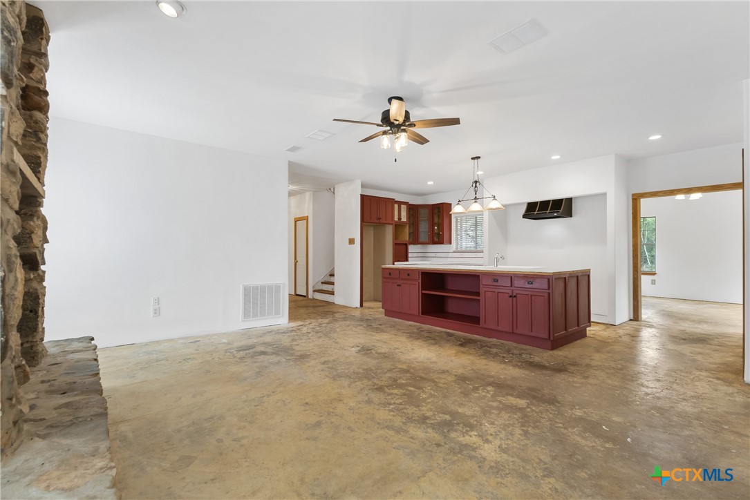 700 Camino De Rancho Wimberley, TX 78676 - Photo 9 of 41 a large bedroom with a large bed and a chandelier