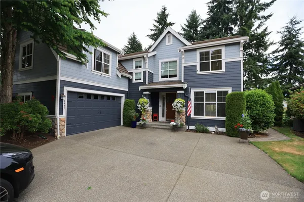 a view of a house with a yard and garage