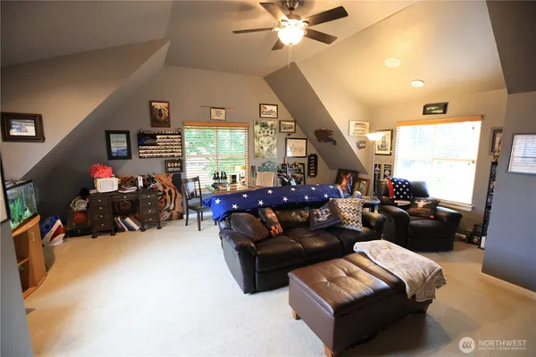 a living room with furniture a large window and a chandelier